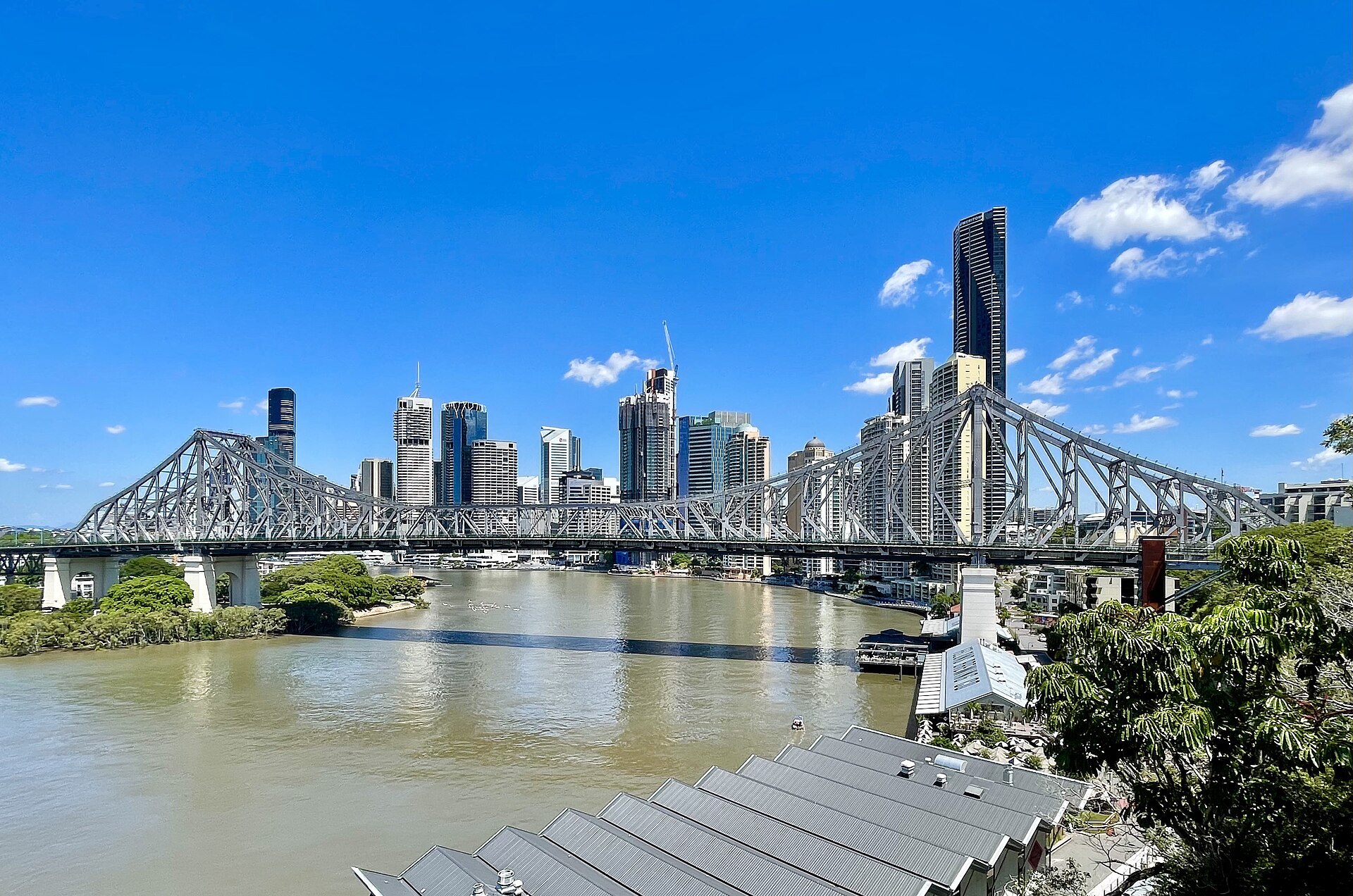 Brisbane's Story Bridge and city skyline over the river under a clear blue sky