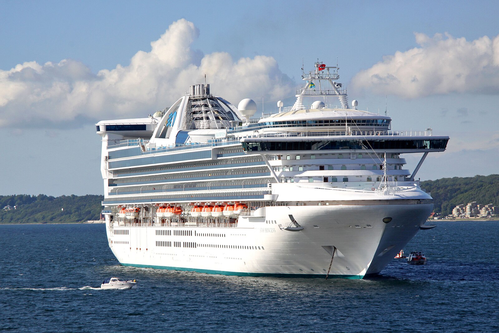 The Grand-class cruise ship now named Carnival Encounter, photographed in her Star Princess days at anchor in bright blue water