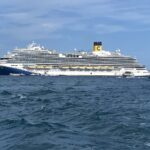 Carnival Firenze cruise ship anchored in bright blue water off Cabo San Lucas, Mexico