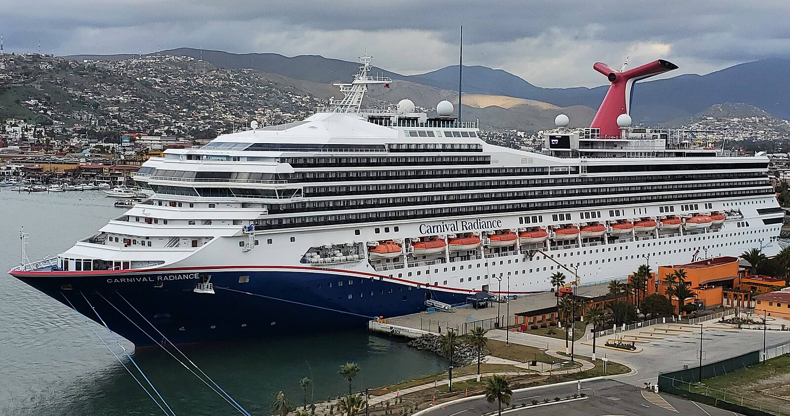 Carnival Radiance cruise ship docked at Ensenada, Mexico, with red funnel and blue hull