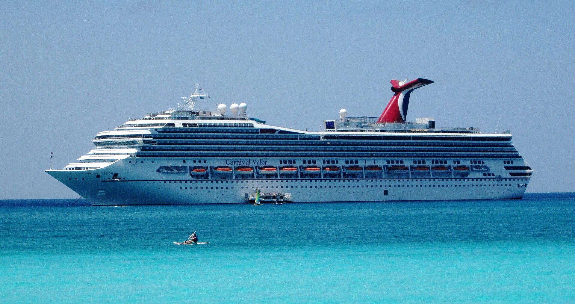 Carnival Valor anchored off Half Moon Cay in bright turquoise water