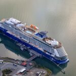 Aerial view of Celebrity Cruises ship Celebrity Edge docked in Juneau, Alaska, on green-blue water