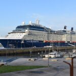 Celebrity Silhouette cruise ship with a navy blue hull docked under a clear blue sky at A Coruna, Spain