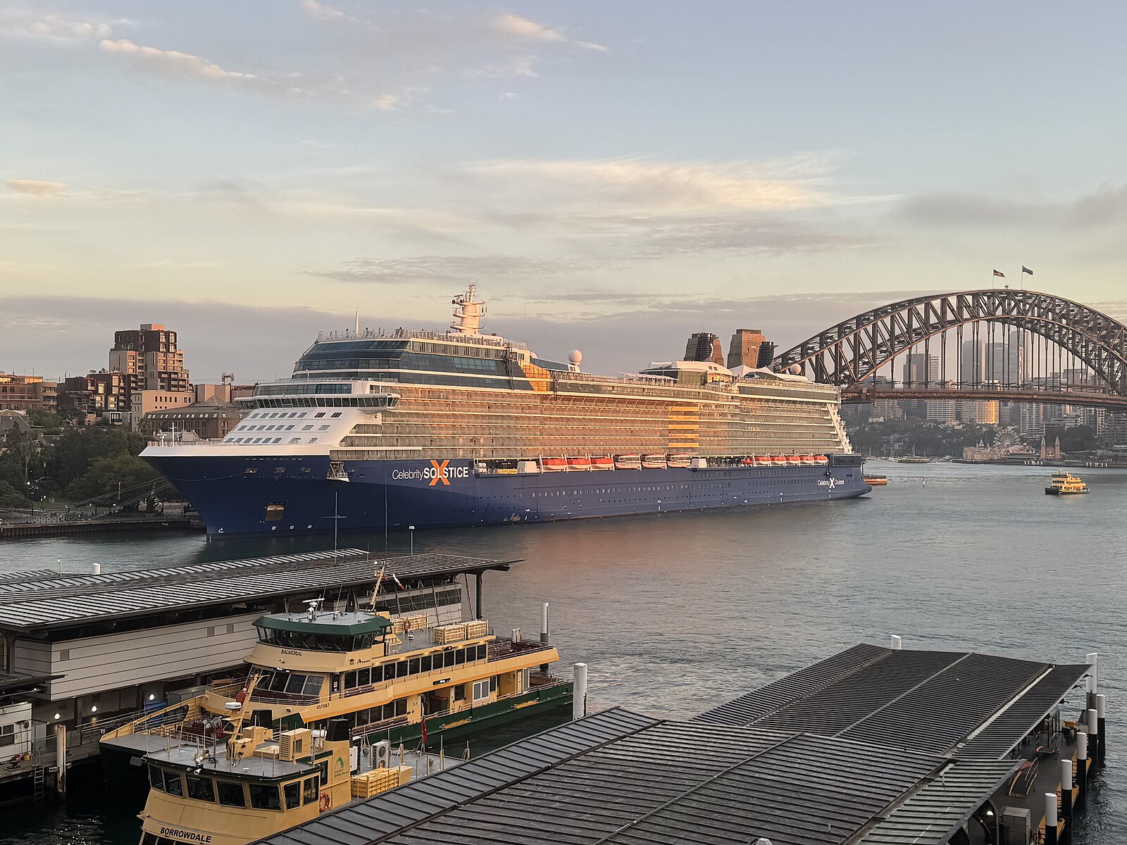 Celebrity Solstice cruise ship berthed in Sydney Harbour at dawn with the Harbour Bridge behind