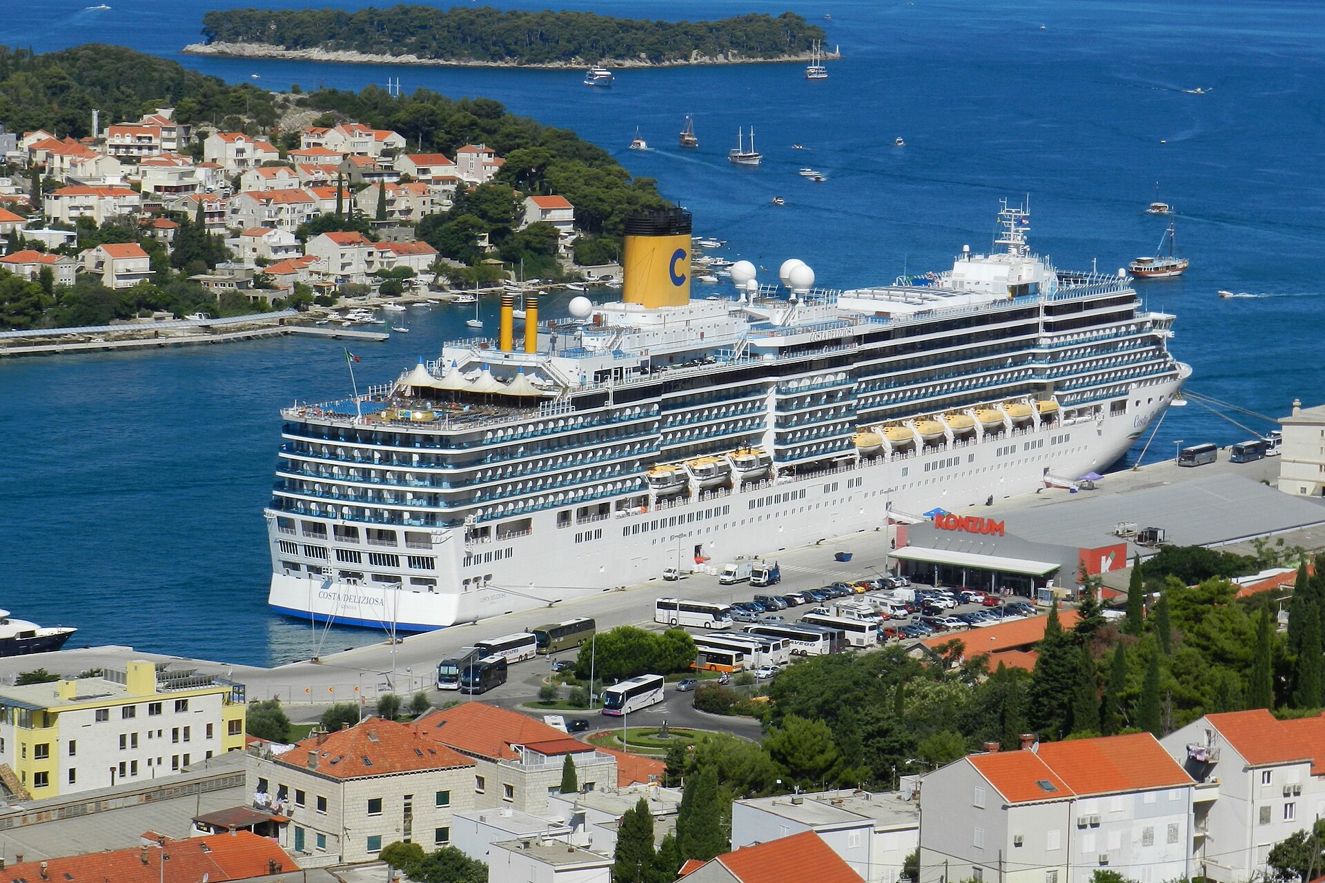 Costa Deliziosa docked at Dubrovnik, Croatia, beside red-roofed houses and deep blue Adriatic water