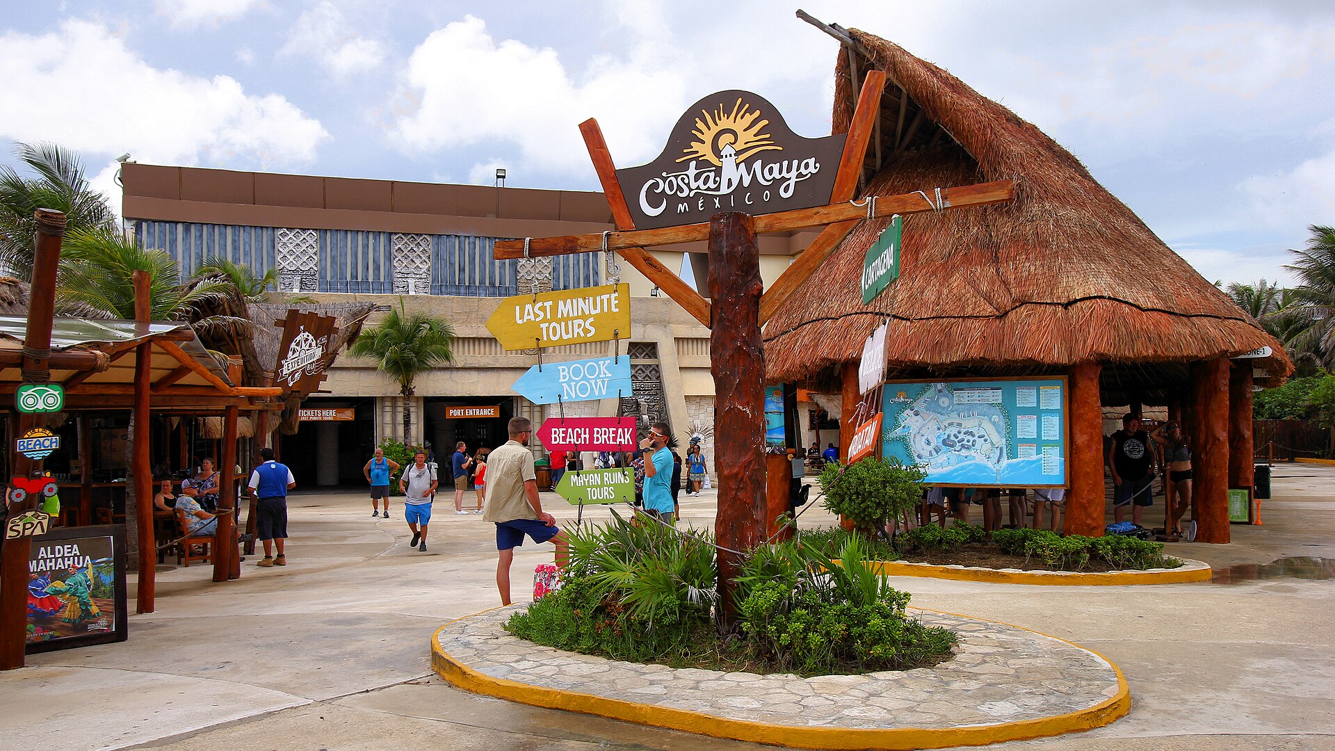 Colorful thatched-roof shops and palm trees at the Costa Maya cruise port in Mexico