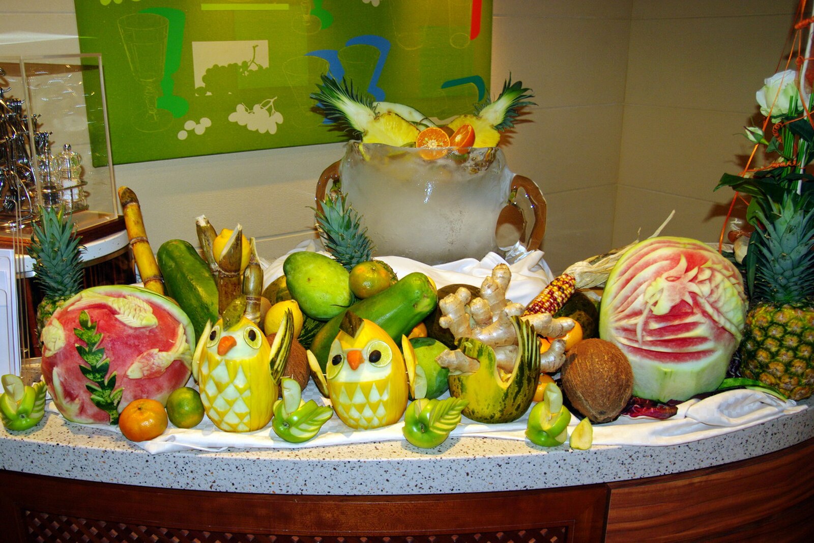 Colorful carved watermelon, pineapple and melon fruit display on a cruise ship restaurant counter