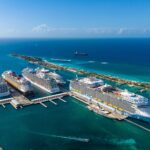 Aerial view of cruise ships docked at Nassau Cruise Port in the Bahamas surrounded by turquoise water