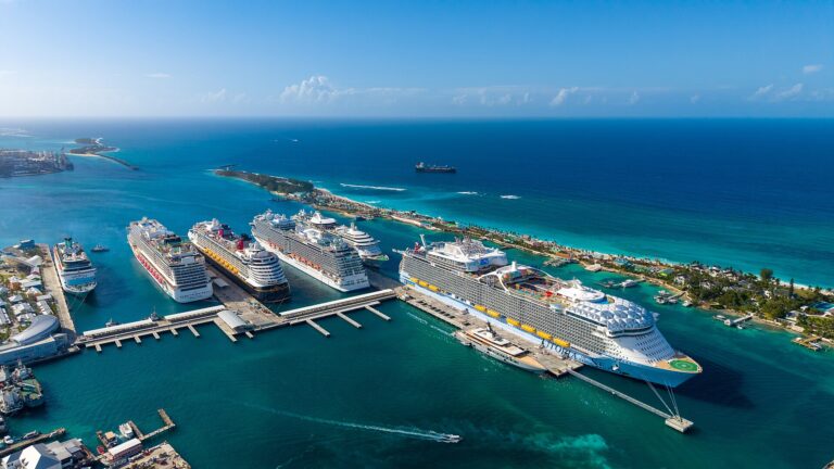 Aerial view of cruise ships docked at Nassau Cruise Port in the Bahamas surrounded by turquoise water