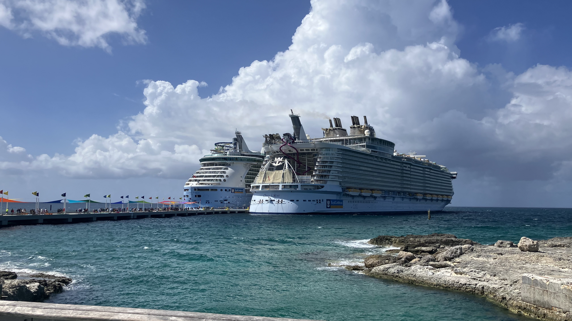 Cruise ships docked at Perfect Day at CocoCay in the Bahamas beside turquoise water