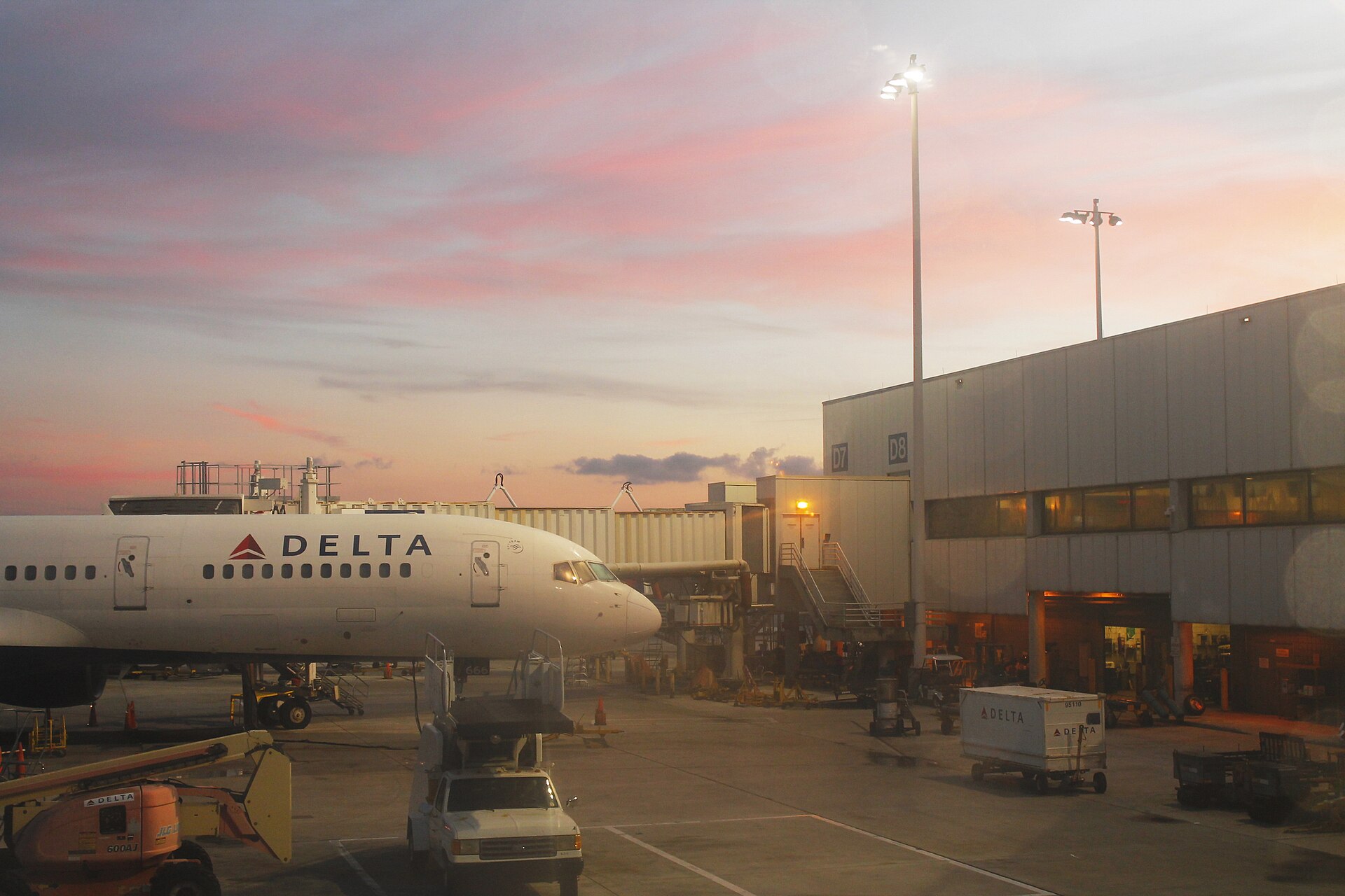 Airliner at a gate under a pink sunrise at Fort Lauderdale-Hollywood International Airport