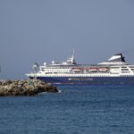 The cruise ship Gemini in Miray Cruises livery sailing out of Rhodes across a deep blue sea