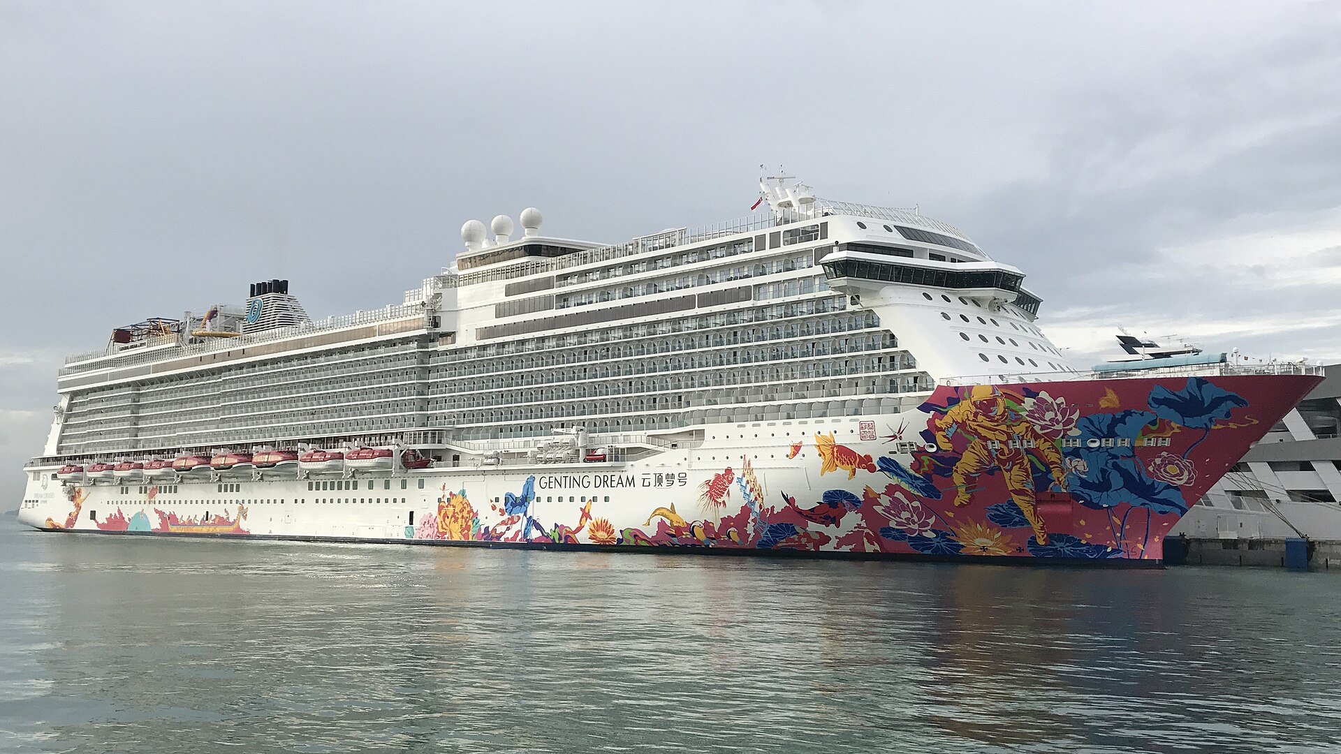 Cruise ship Genting Dream with a brightly painted hull of flowers and fish, docked at Marina Bay Cruise Centre Singapore