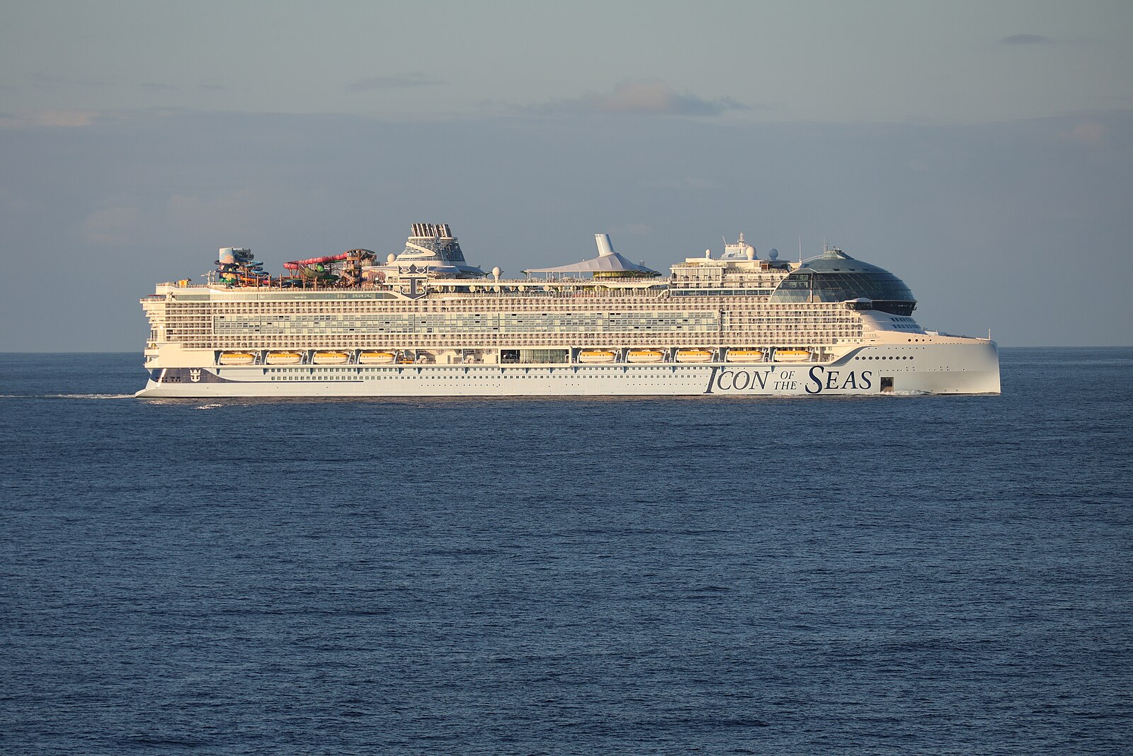 Icon of the Seas sailing on deep blue Caribbean water in late afternoon light