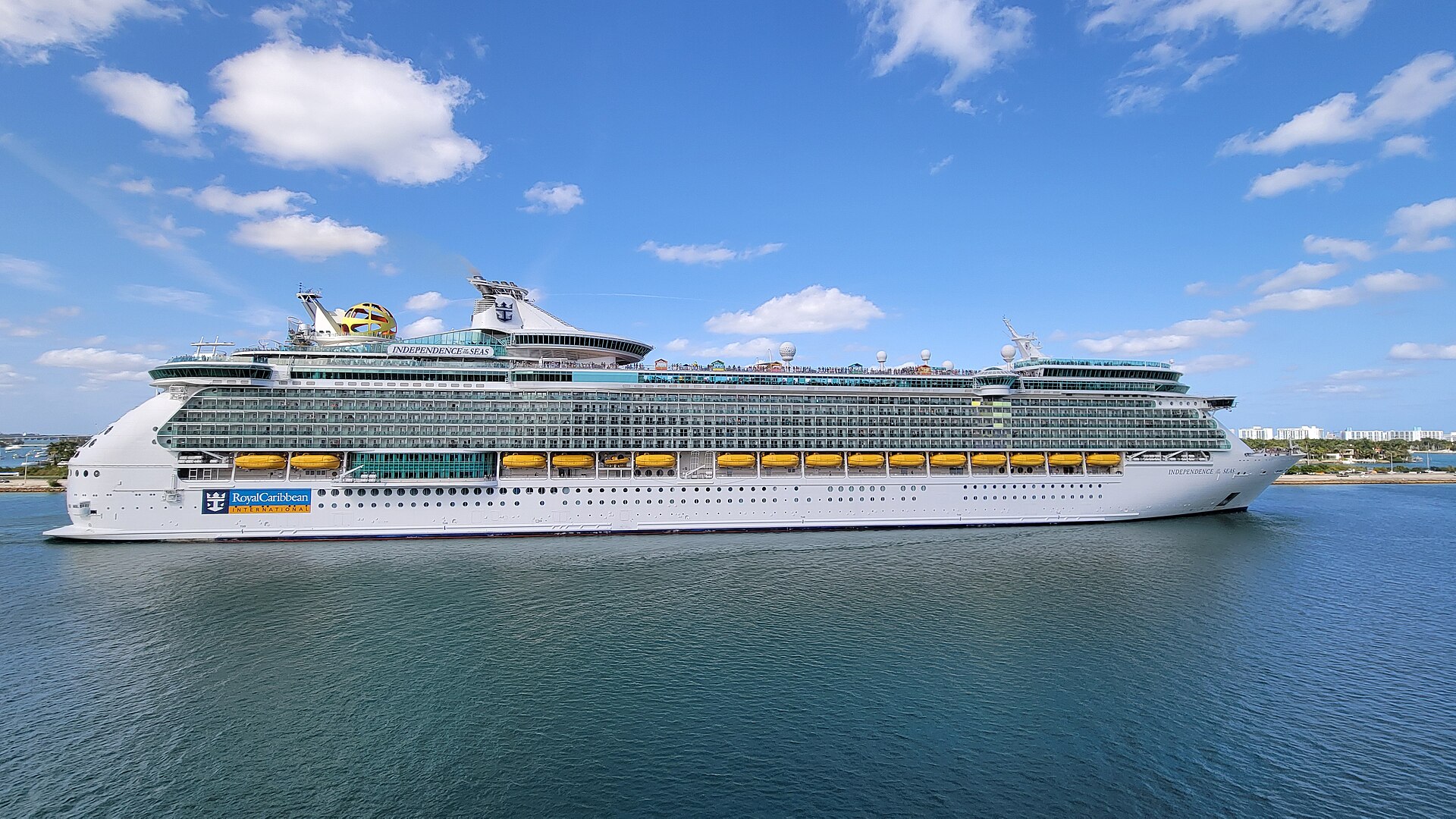 Royal Caribbean's Independence of the Seas sailing past Miami under a bright blue sky