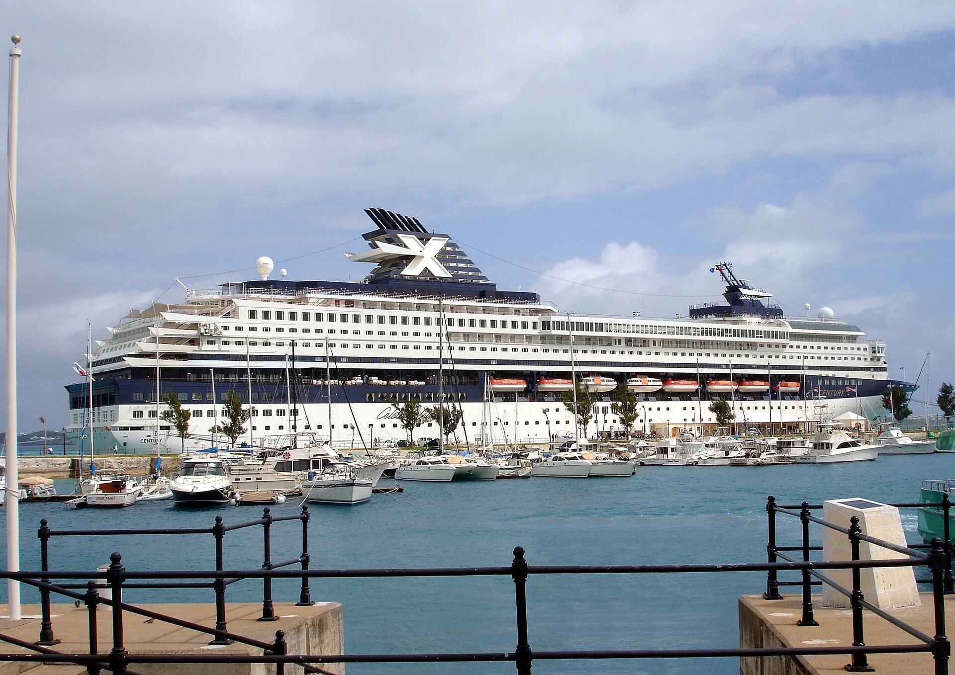 Cruise ship docked at King's Wharf in Bermuda behind a marina of small boats