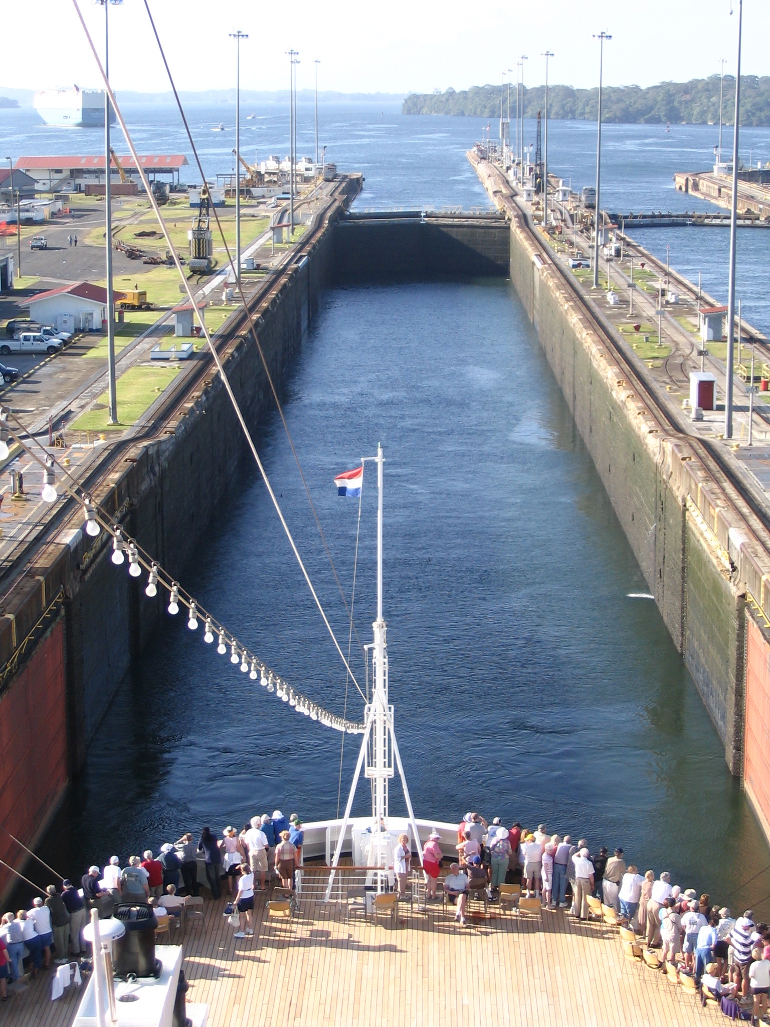 Passengers on the bow of Holland America's Maasdam watching as the ship enters a Gatun Locks chamber on the Panama Canal
