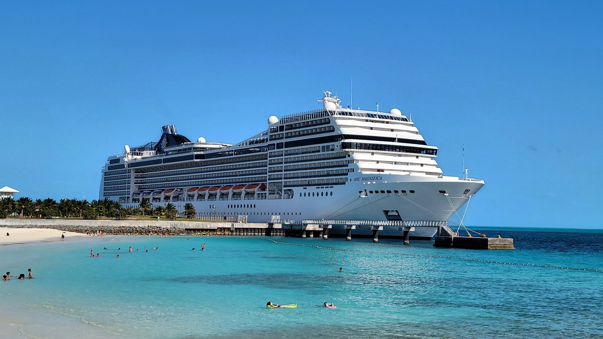 MSC Magnifica docked at Ocean Cay with swimmers in turquoise water in front