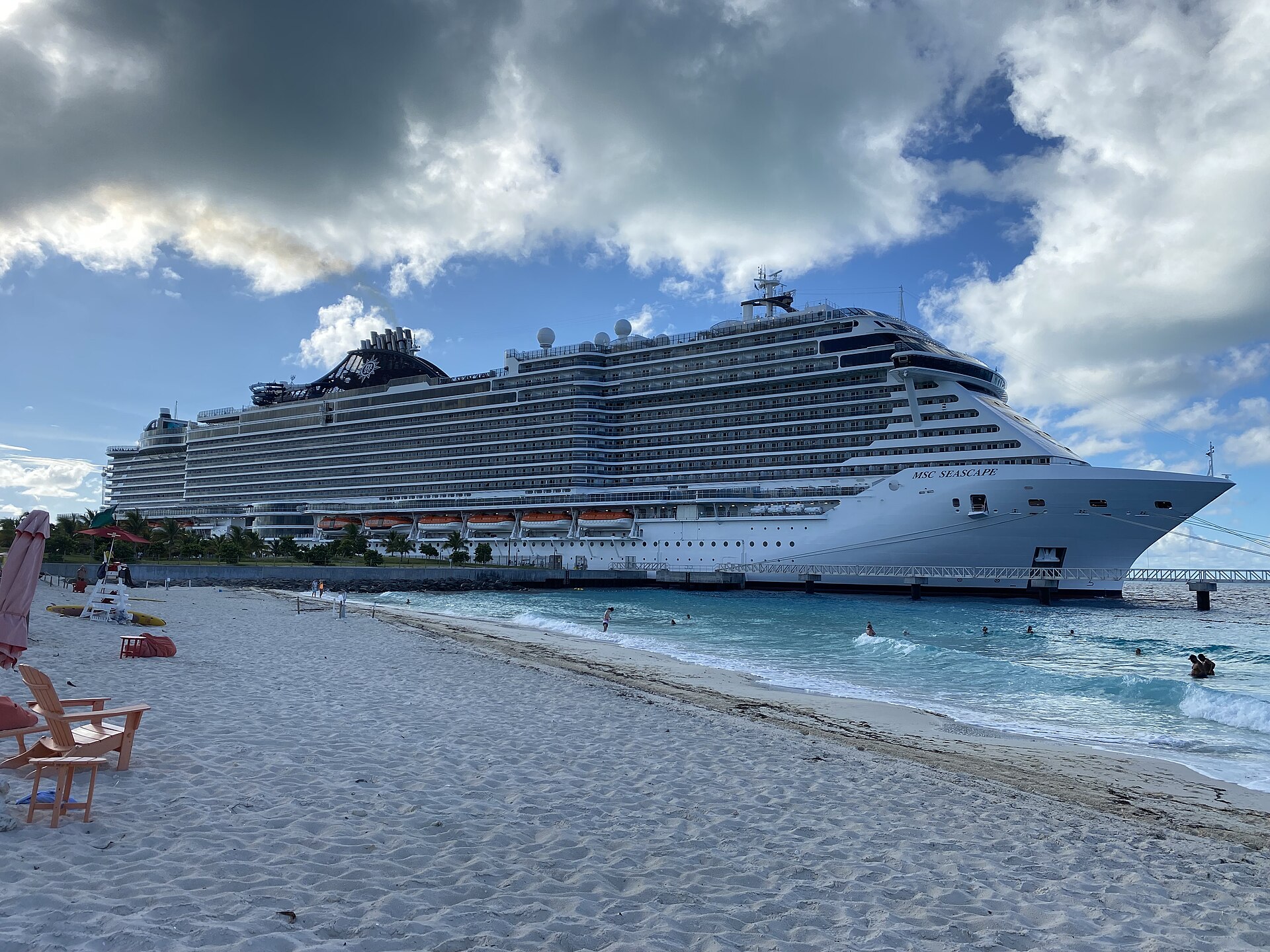 MSC Seascape docked beside a white sand beach and turquoise water