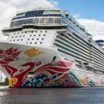 Norwegian Joy cruise ship seen bow-on, showing her painted hull art above the waterline