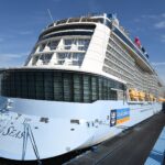 Royal Caribbean's Quantum of the Seas docked under a bright blue sky