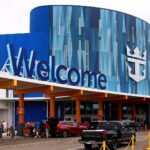 The colourful Royal Caribbean cruise terminal at Pier 10 in Galveston, Texas, with cars unloading outside on embarkation day