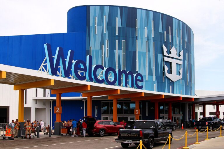 The colourful Royal Caribbean cruise terminal at Pier 10 in Galveston, Texas, with cars unloading outside on embarkation day