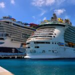 Royal Caribbean ships Icon of the Seas and Mariner of the Seas docked in turquoise water at Cozumel, Mexico