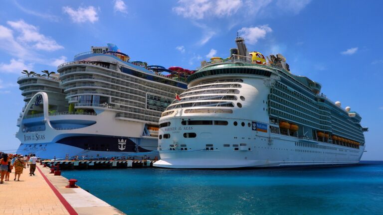 Royal Caribbean ships Icon of the Seas and Mariner of the Seas docked in turquoise water at Cozumel, Mexico