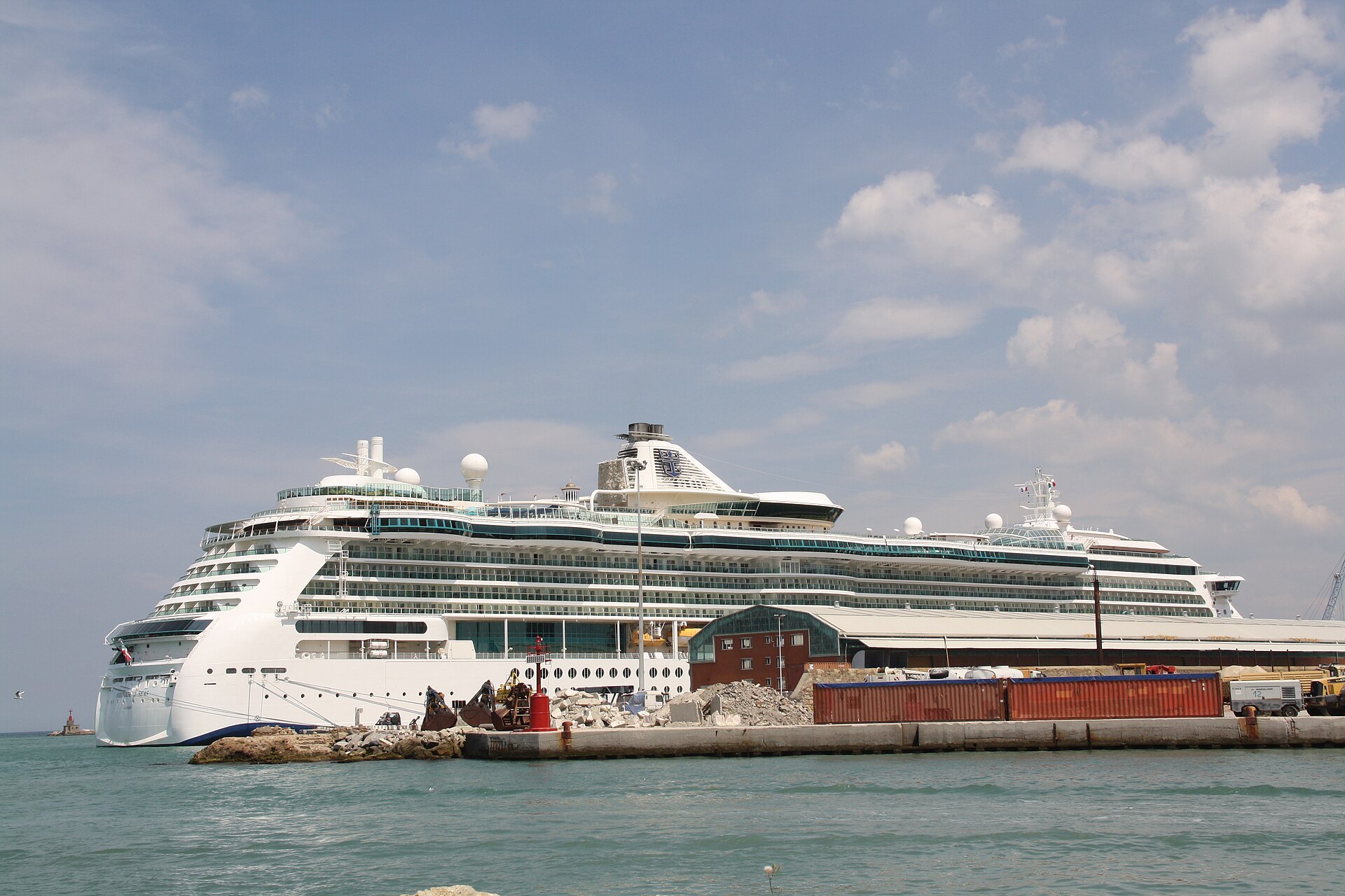 Royal Caribbean cruise ship Serenade of the Seas berthed under a blue sky with white clouds