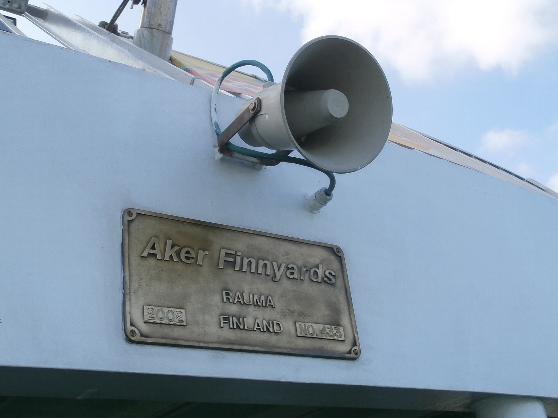 Horn loudspeaker mounted on the outside of a passenger ship