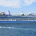 Royal Caribbean's Star of the Seas sailing off Cadiz, Spain, on deep blue water with its colourful waterslides on the top deck