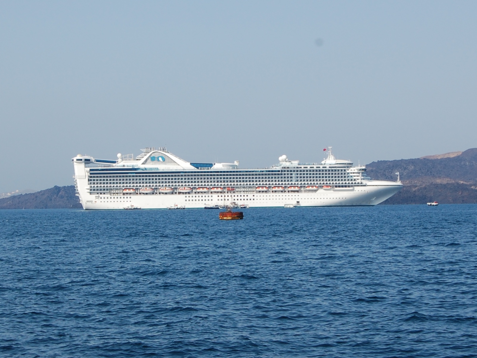 White cruise ship Star Princess anchored on deep blue water off Santorini, Greece