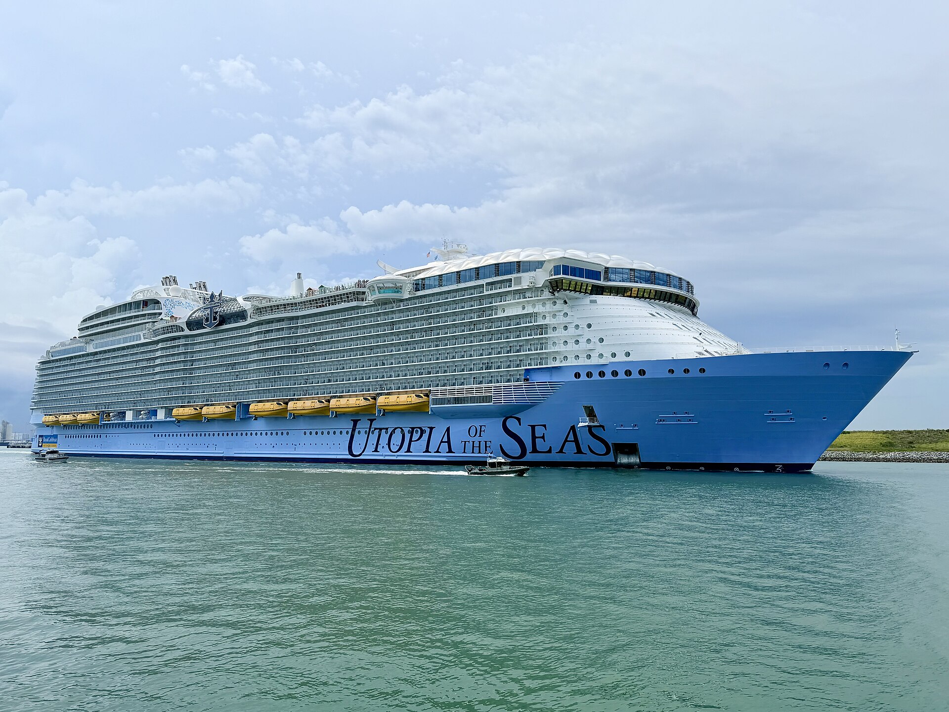 Utopia of the Seas with its bright blue hull sailing out of Port Canaveral, Florida