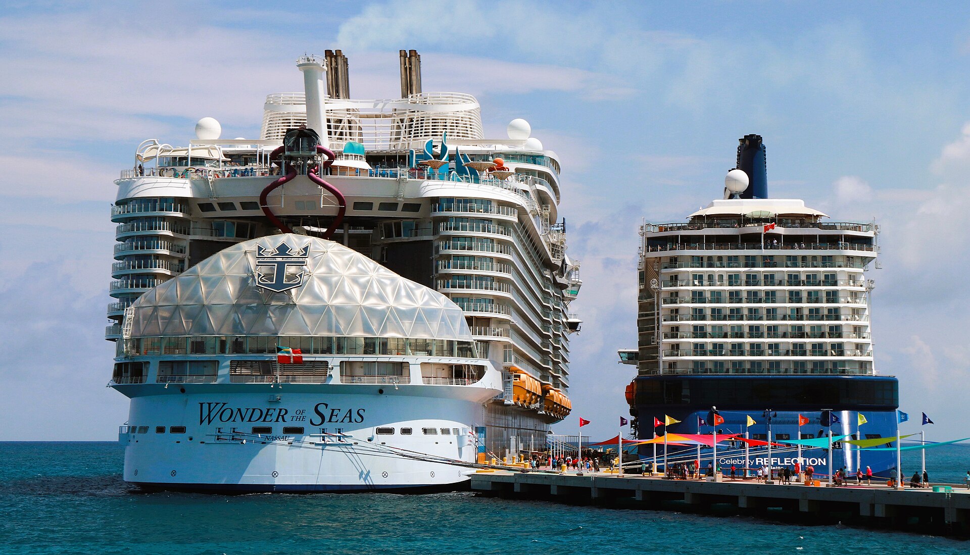 Royal Caribbean's Wonder of the Seas and a Celebrity Cruises ship docked at Perfect Day at CocoCay in blue Bahamas water