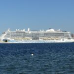 AIDAnova cruise ship sailing out of Kiel on deep blue water under a clear sky
