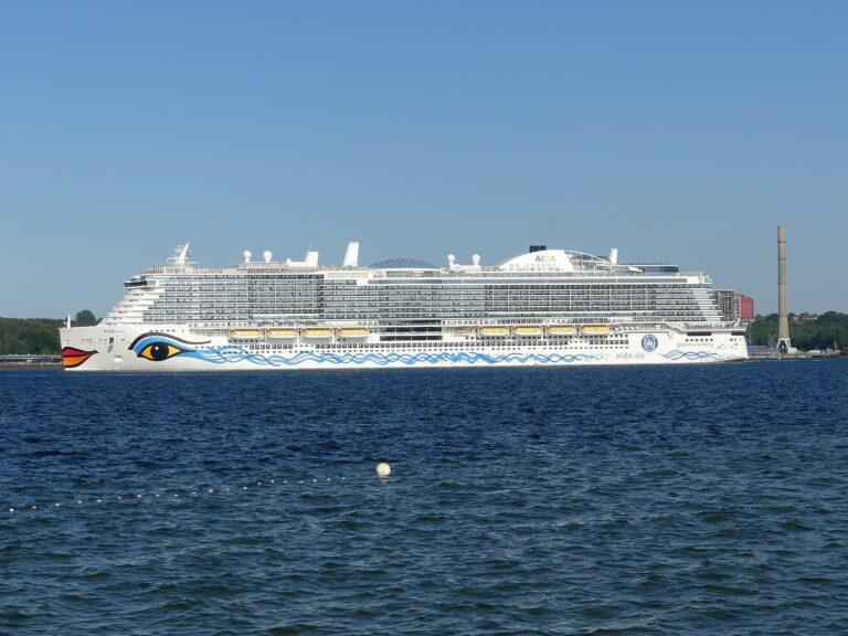 AIDAnova cruise ship sailing out of Kiel on deep blue water under a clear sky