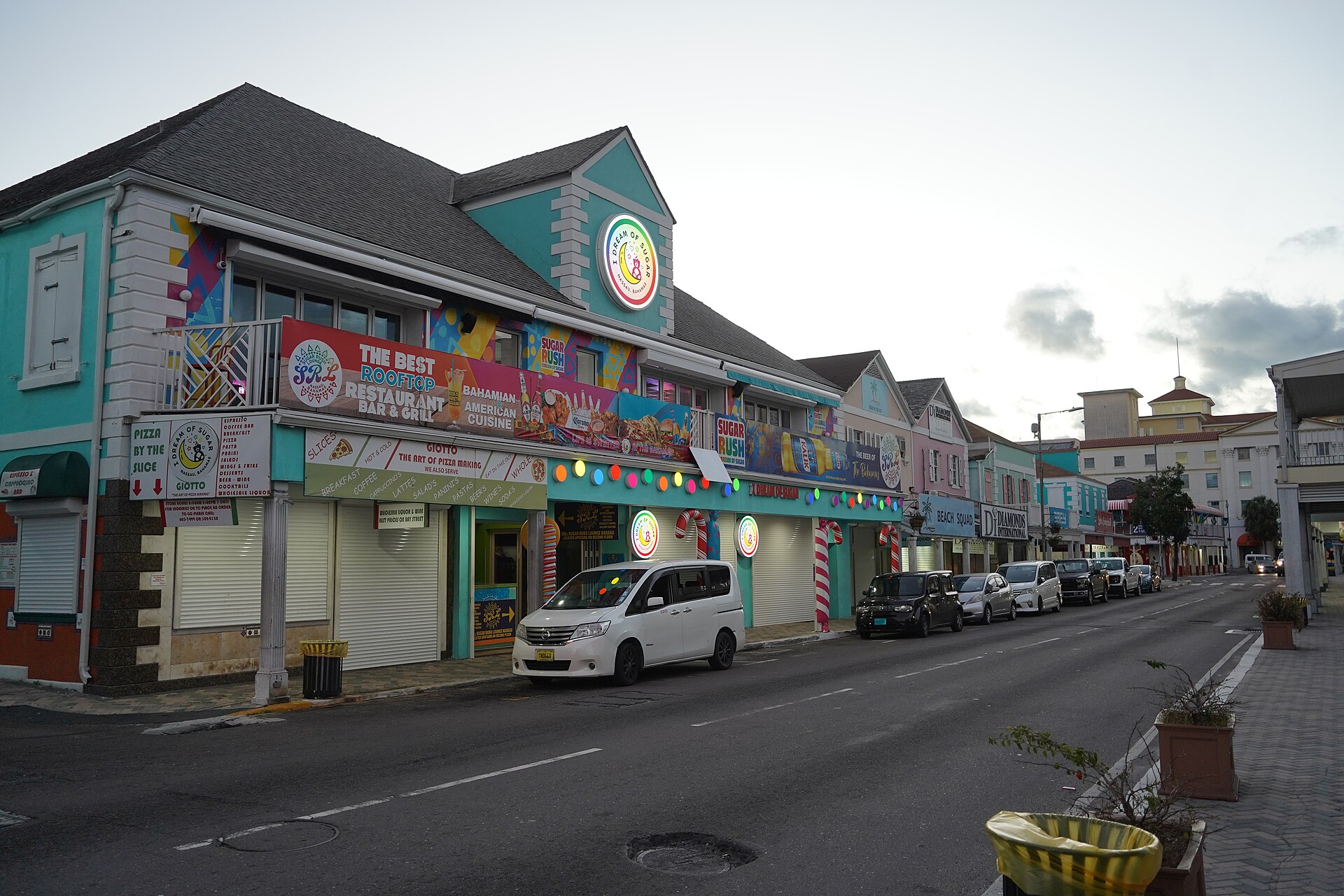 Colourful shopfronts and traffic on Bay Street in downtown Nassau, Bahamas