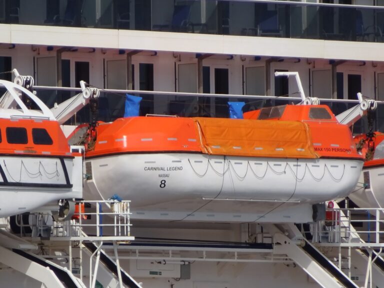 Orange lifeboat number 8 hanging on the side of Carnival Legend in Tallinn