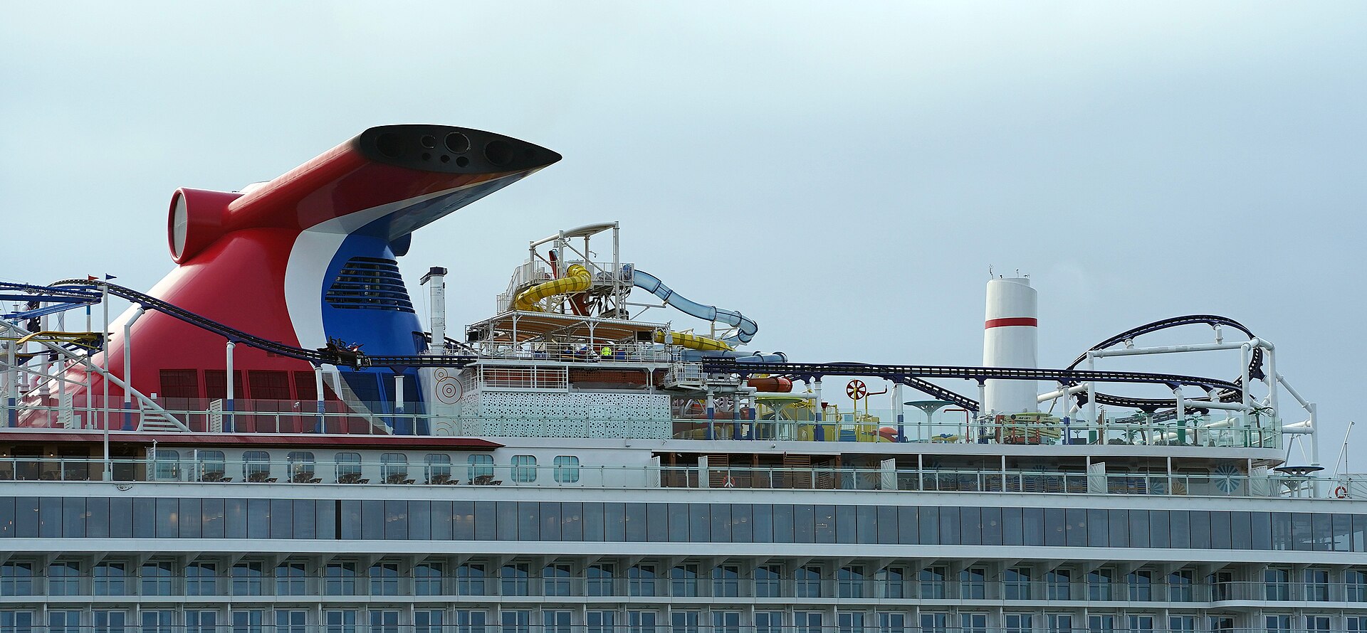 The red, white and blue funnel and roller coaster track on the top deck of Carnival Mardi Gras