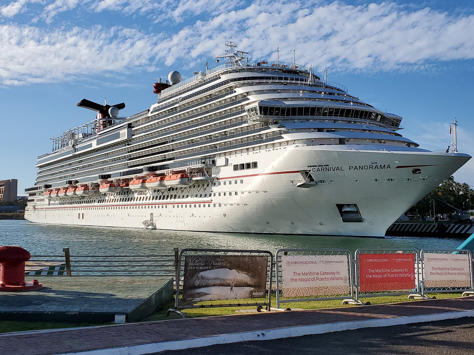 Carnival Panorama docked at the Puerto Vallarta cruise port under a blue sky