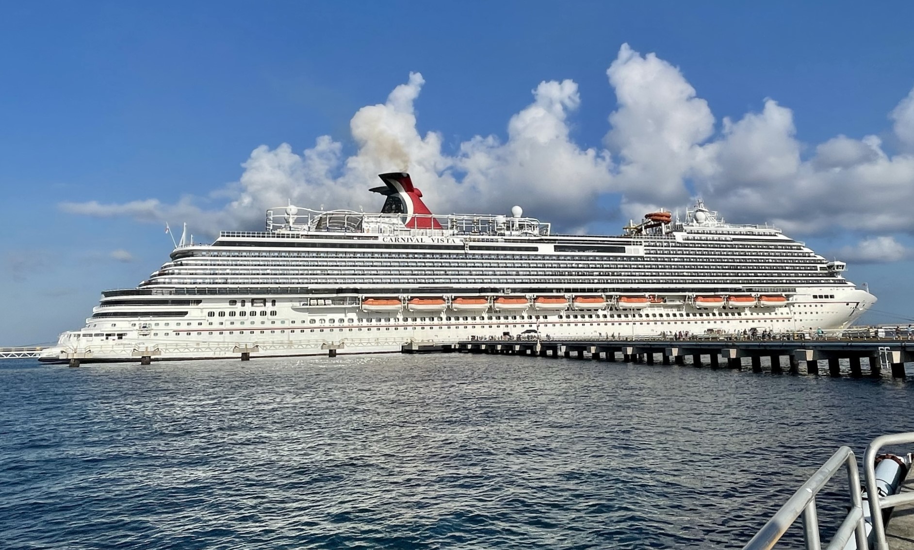 Carnival Vista alongside the pier in Cozumel under a bright blue sky