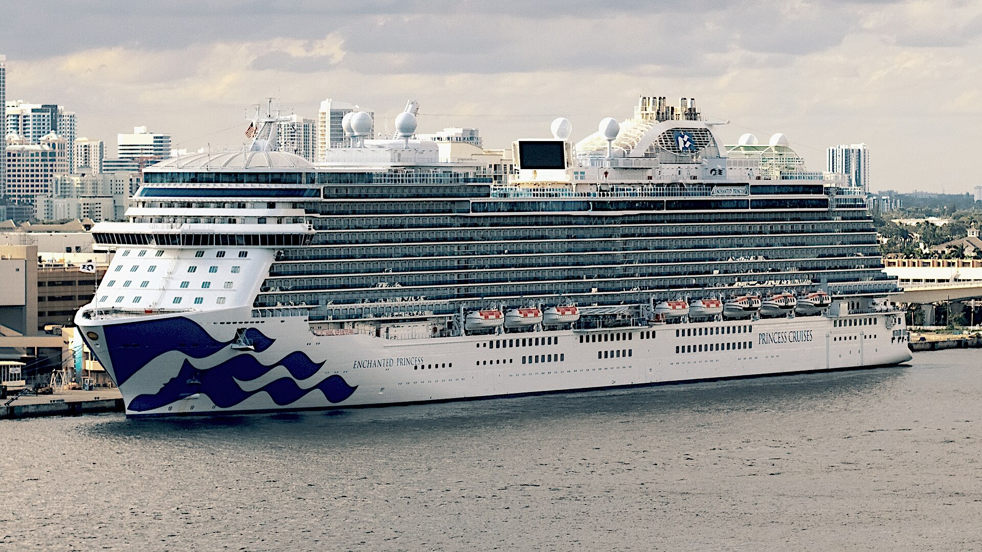 Princess Cruises' Enchanted Princess docked, with its blue Sea Witch logo on the bow
