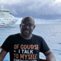 Ernie, editor of Cruise Chaos, on a cruise with the Norwegian Star behind him