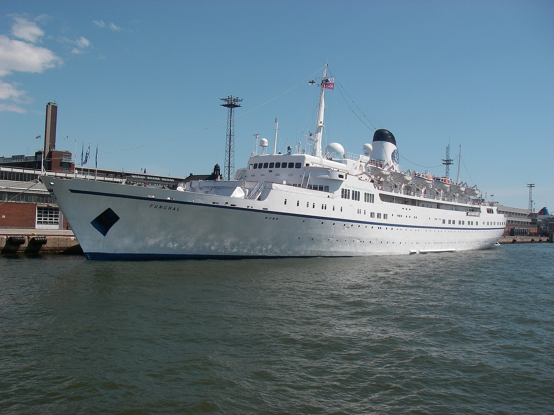 The all-white cruise ship Funchal moored in Helsinki harbour under a blue sky