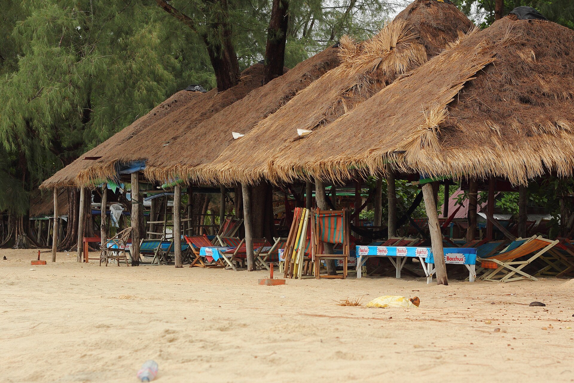 Thatched beach huts and deck chairs on Hawaii Beach in Sihanoukville, Cambodia