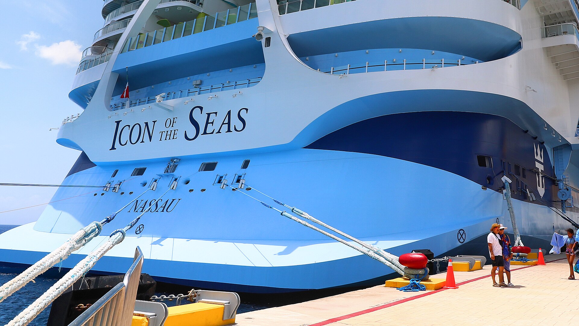 The stern of Icon of the Seas tied to the pier with mooring lines