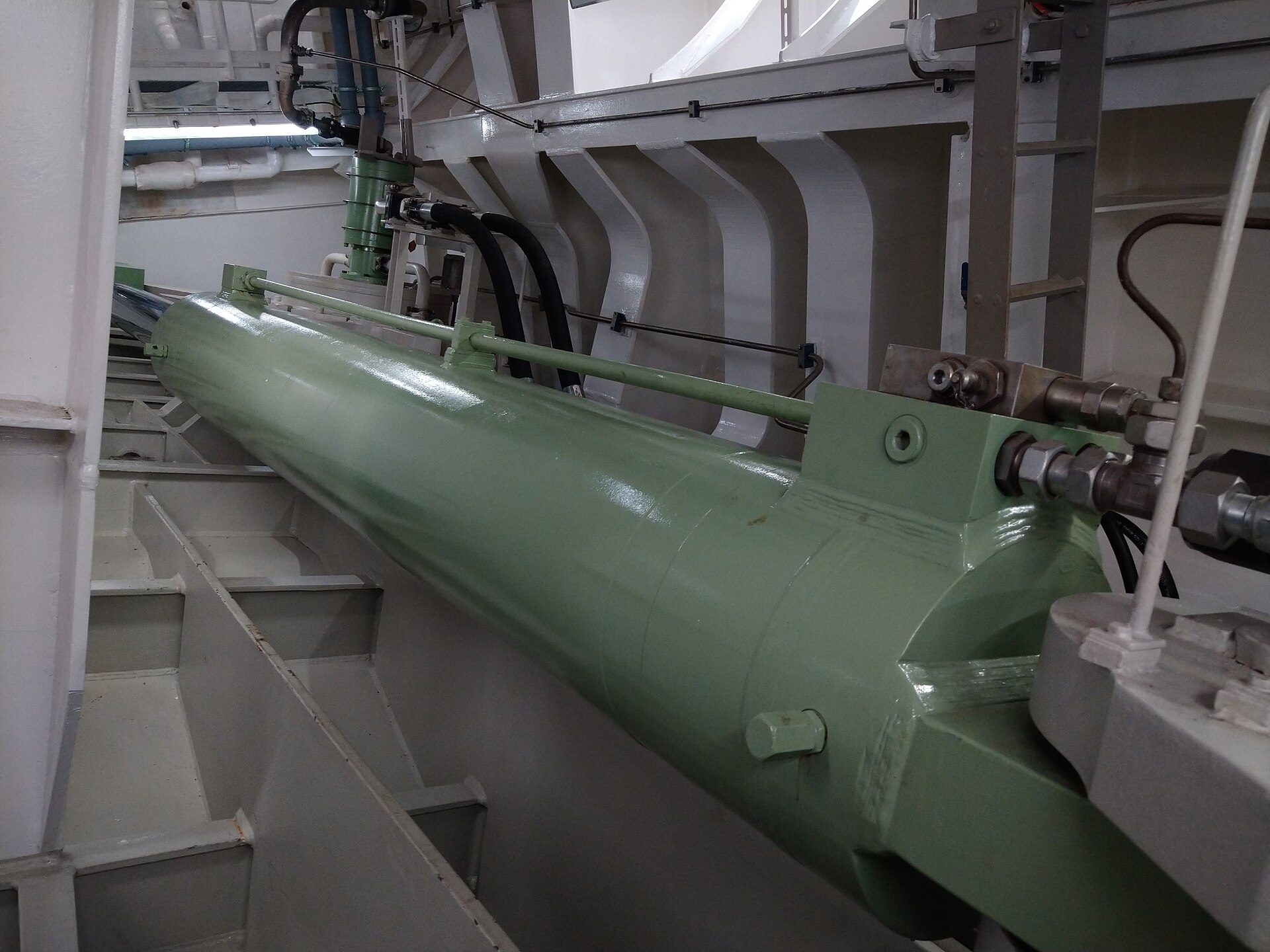 A large green hydraulic cylinder that moves the starboard stabilizer fin inside the cruise ship Nieuw Statendam