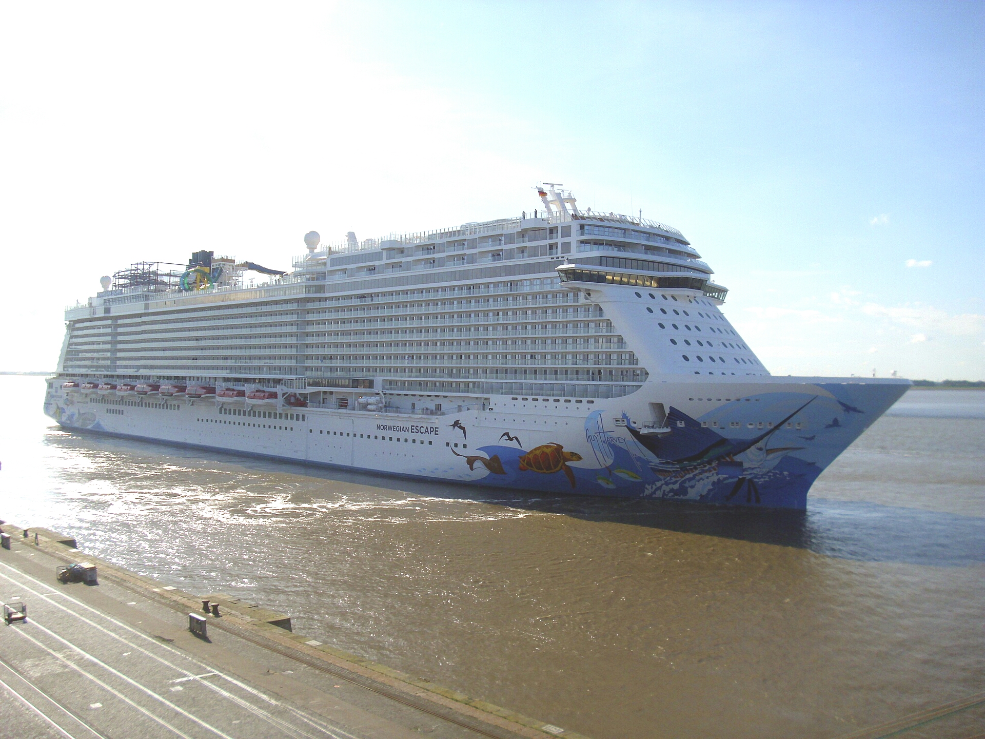 Norwegian Escape cruise ship with colorful sea-life hull art under a bright sky