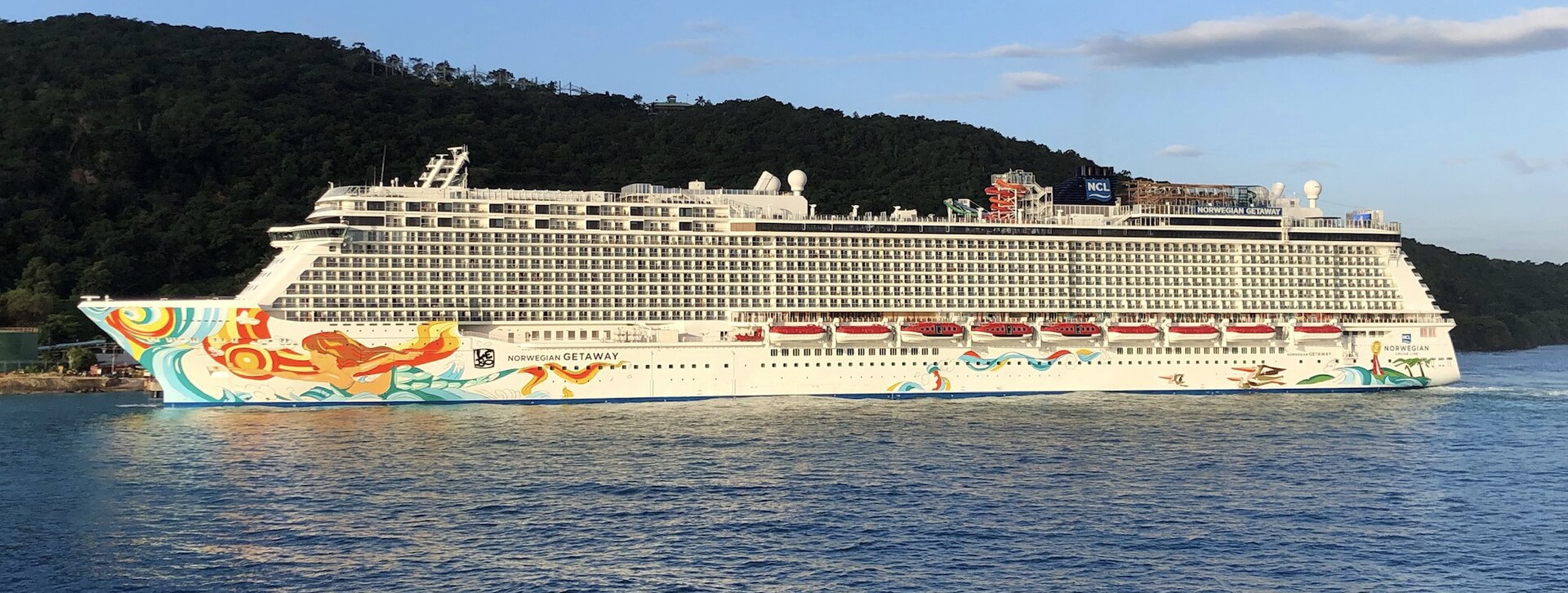 Norwegian Getaway sailing past green hills at Ocho Rios, Jamaica